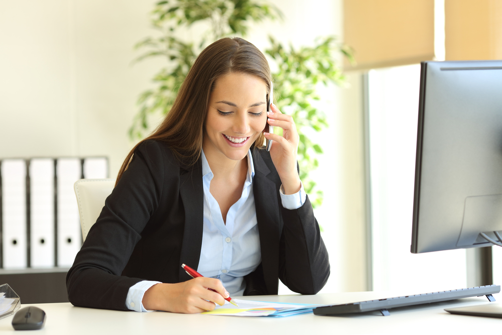 executive woman discussing pricing on a cell phone call